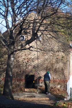 Man sweeping leaves